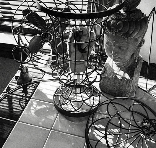 Still life with bust of Buddha, table fan and venetian blinds