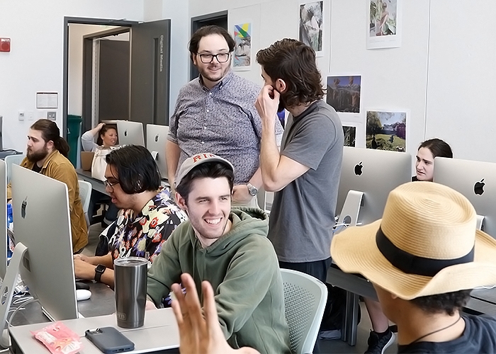 Students in filmmaking class at their computers interacting