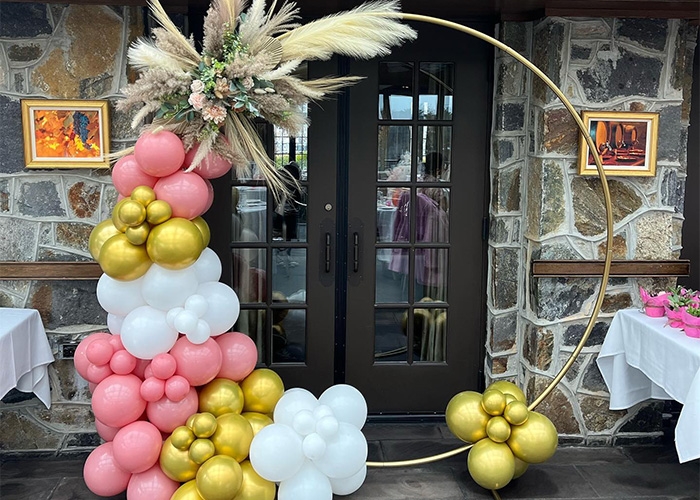 Balloons circling the entrance to a building