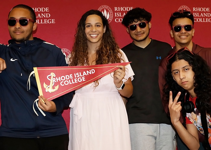 Admissions counselor poses with Anchor to Success students