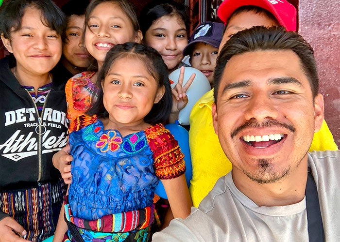 Roberto poses with smiling children