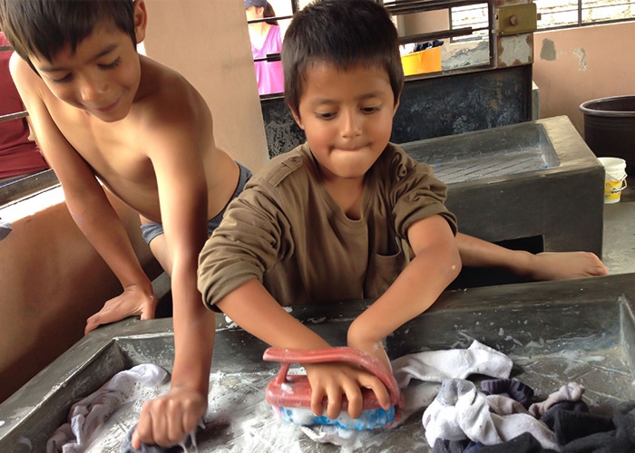 Little boys wash socks