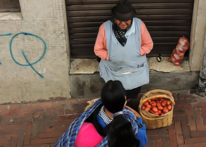 Two women on street stop to talk