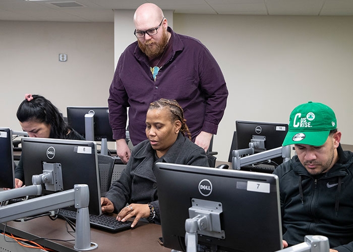 IT instructor overlooking students at computers