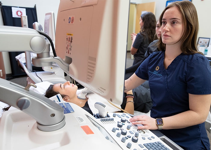 Sonography students practice in lab