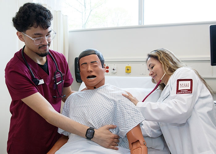 Gabriel and Mirna check vital signs on a manikin. 