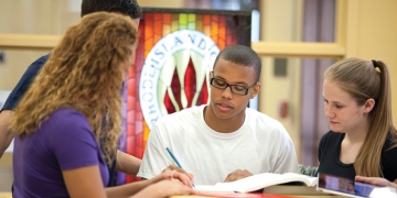 Students in the library working together 