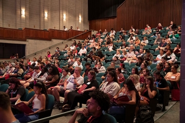 Students and families in the RIC auditorium for orientation presentation