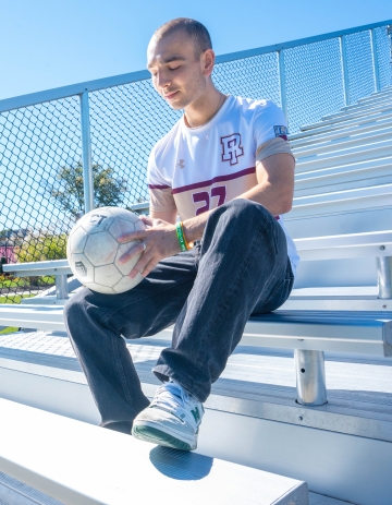 Joe Kelly looking down at soccer ball 