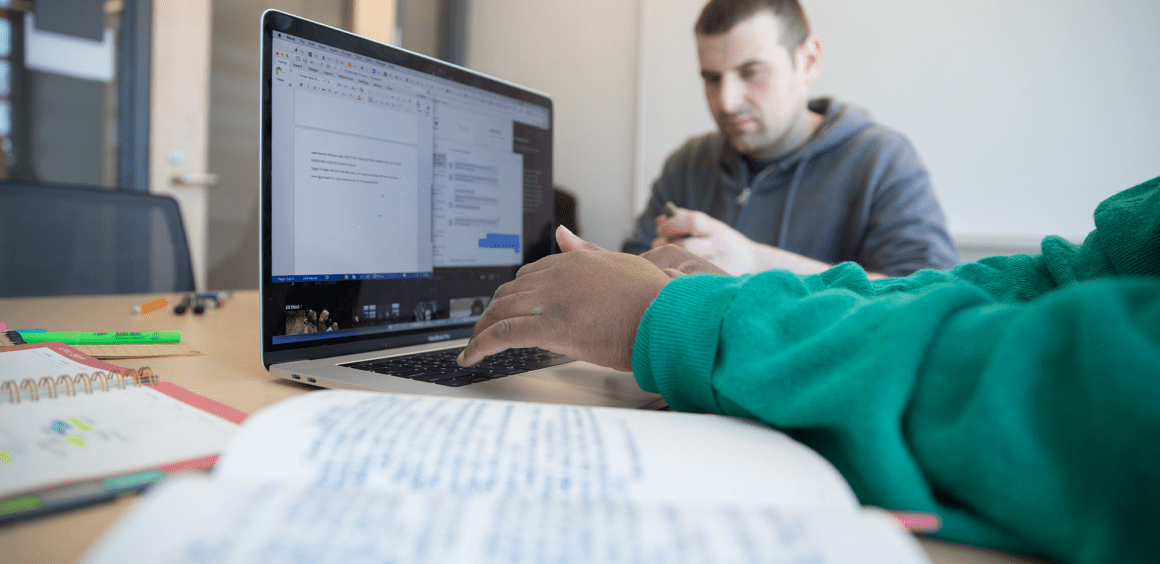 Close up of student working on a laptop