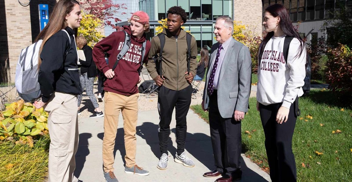 RIC interim president and students outside