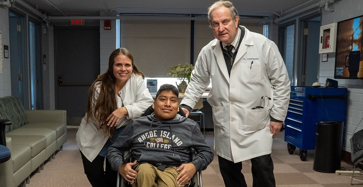 Dr. Paul Dionisopoulos and Director Jennifer Fox with student in wheelchair