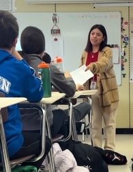 Litzy Ramos hanging papers to her students