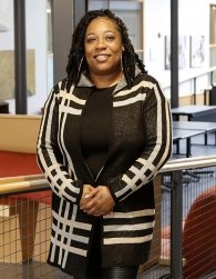 Keishana Dawkins stands in lobby of School of Social Work