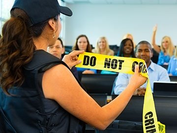 Police officer conducting a training with a class