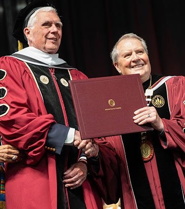Honorary degree being presented by President Warner