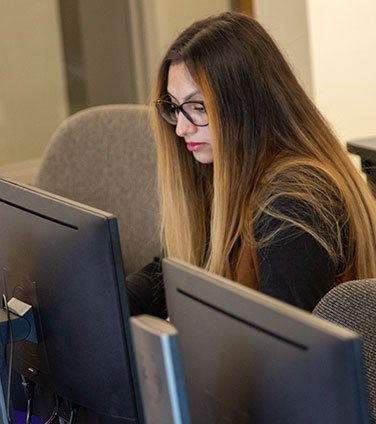 Student working in row of computers