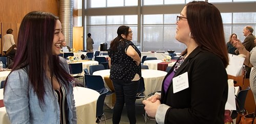 ​​​​​From left, c​ommunication major Erika Santilli and alumna Stephanie Mandeville ’06 talk shop f​ollowing a panel discussion.​