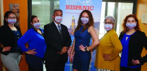 RIC students and RI Hispanic Chamber of Commerce staff members pose for a photo in front of a banner