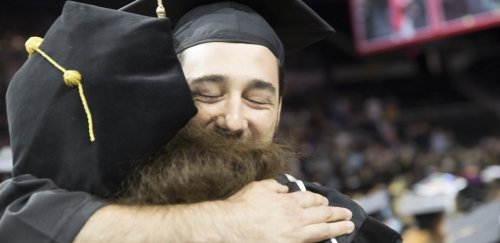 Graduates embracing at RIC Commencement