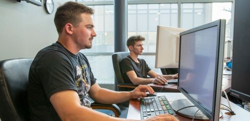 Two students working at computers in Finance Lab