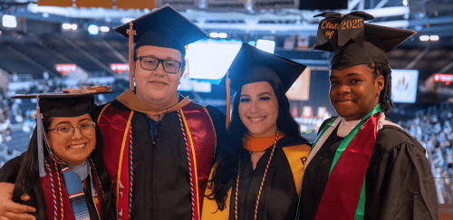 Graduates standing together in cap and gown