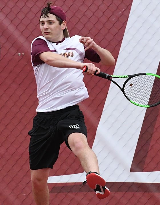 RIC student Eli Gouin playing tennis