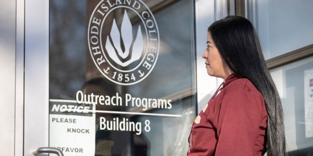 Leidy in front of the outreach building at Rhode Island College