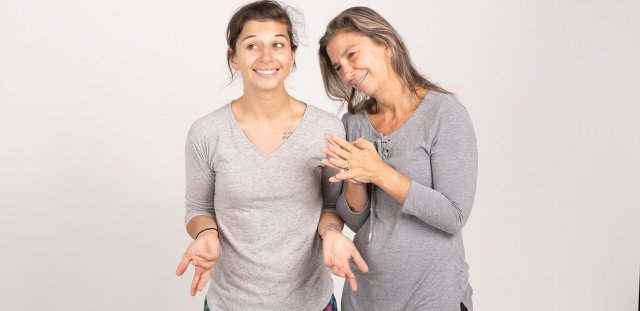 Shannon Curley and her mother, RIC alumna Christine Curley, stand against a white background