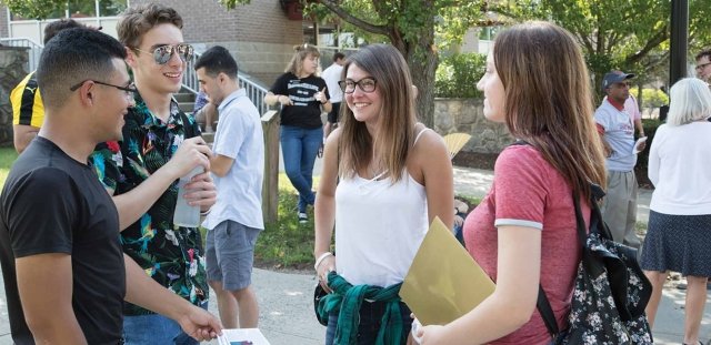 Students talking in small groups on the quad