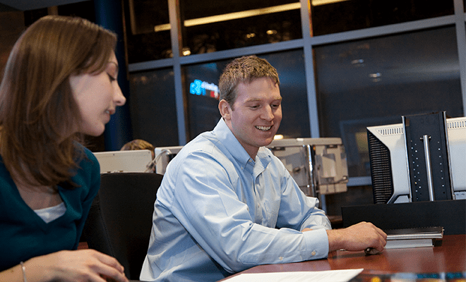 Two students talking in a computer lab