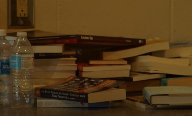Two water bottles and pile of books