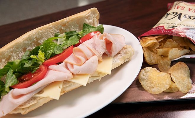 Sub sandwich with bag of potato chips